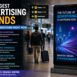 Large digital airport advertising display inside a modern international airport terminal showcasing a premium brand campaign with travelers walking through the departure area.